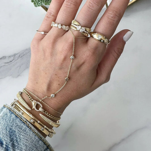 Cadena de mano con diamantes en bisel y tres diamantes en oro de 14 k